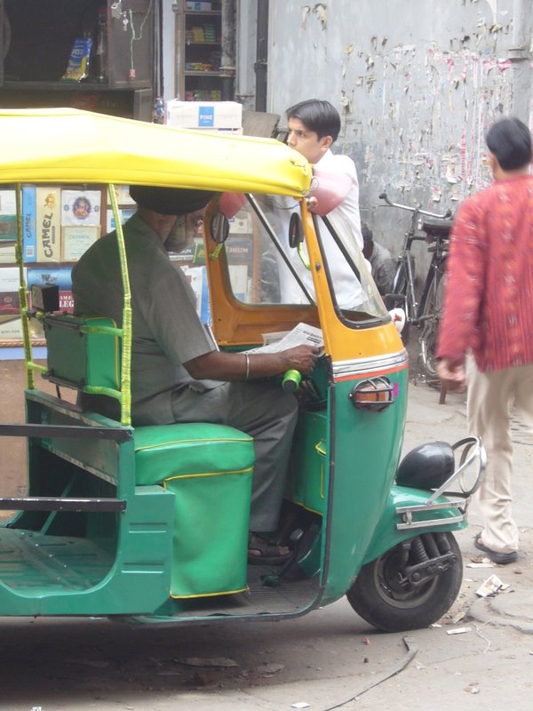 Autorickshaw driver with netted beard.